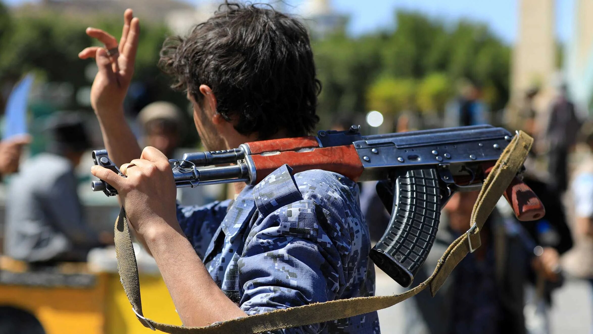 A fighter loyal to Yemen's Houthi rebels performs a traditional dance during a visit to the grave of slain Huthi political leader Saleh al-Sammad in Sanaa on 31 January 2022.
