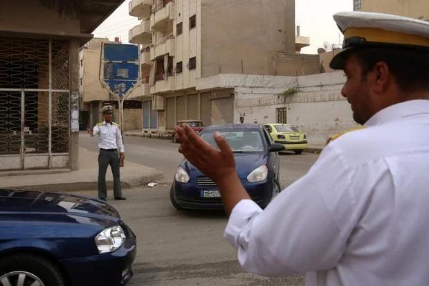 Syrian government traffic policemen monitor a road in Qamishli (AFP)