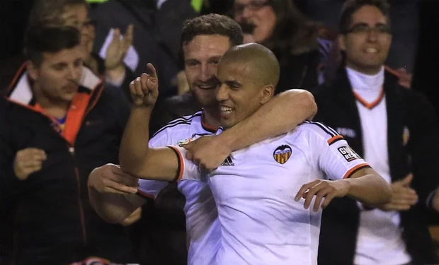 Valencia's French midfielder Sofiane Feghouli (R) celebrates his goal with Valencia's German defender Shkodran Mustafi during the Spanish league football match in Valencia on 13 December, 2014 (AFP)