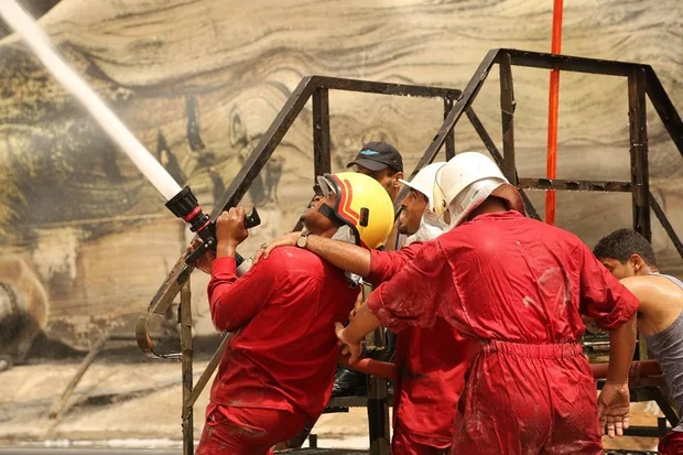 Firefighters tackle the blaze (MEE / Akram Almighri)