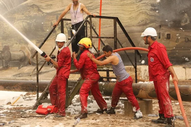 Firefighters tackle the blaze (MEE / Akram Almighri)