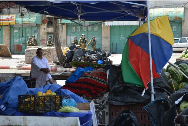 Man selling vegetables in Hebron (MEE/By Sheren Khalel and Matthew Vickery)
