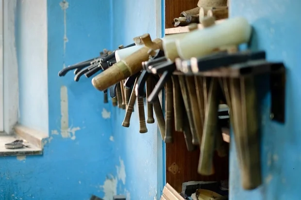 The silversmiths' tools hang on the wall of a workshop in the Büyük Yeni Han.(MEE/Paul Osterlund)