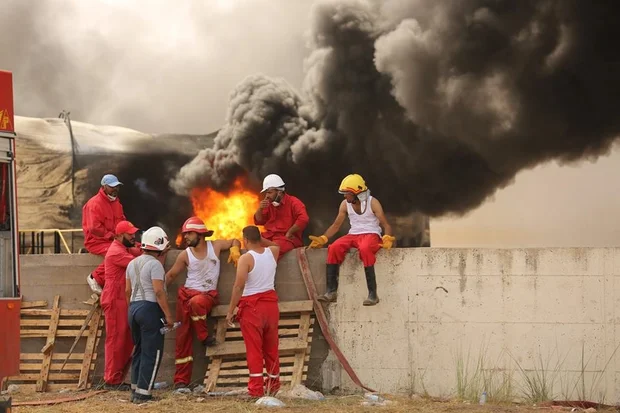 Fire crews take a brief break (MEE / Akram Almighri)