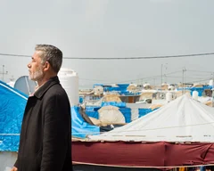 Abdul Hamid walks down a side road Bardarash Refugee Camp (MEE/Taylor Smith)