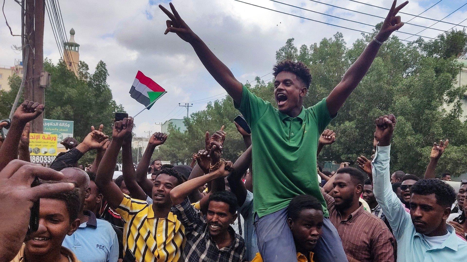 People take to the streets of Port Sudan to celebrate the advance of Sudanese military forces and allied armed groups on Wad Madani on 11January (AFP)