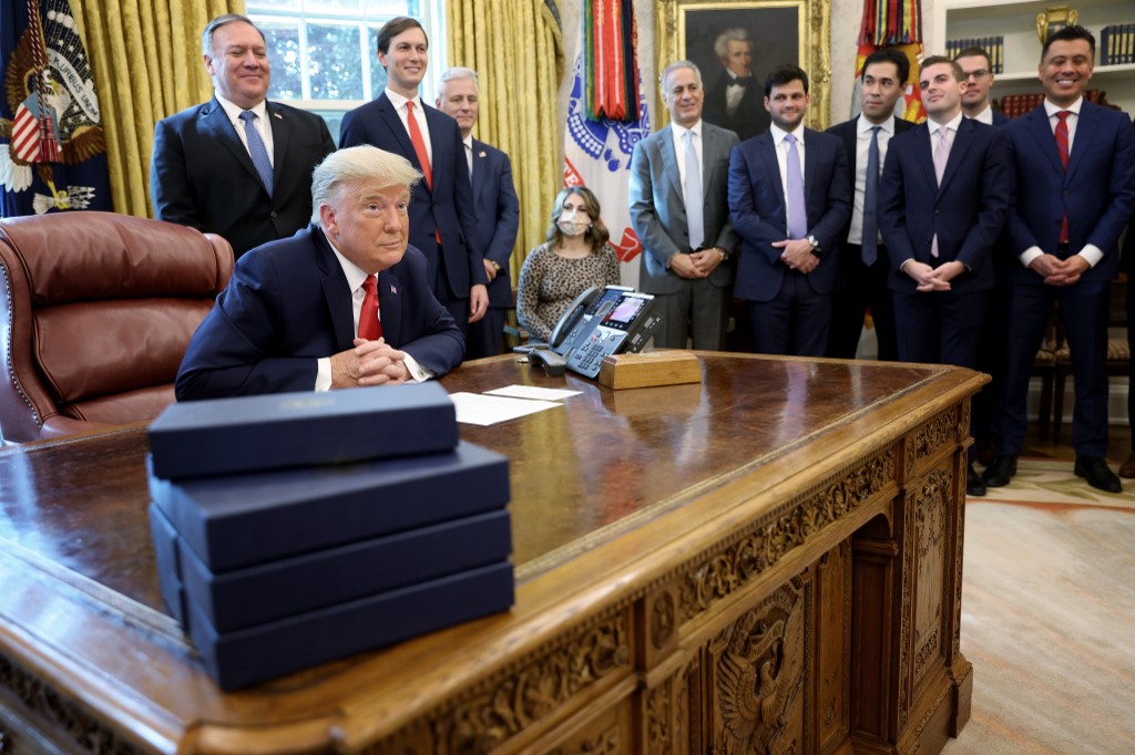 US President Donald Trump discusses the Sudan-Israel deal in Washington on 23 October (AFP)