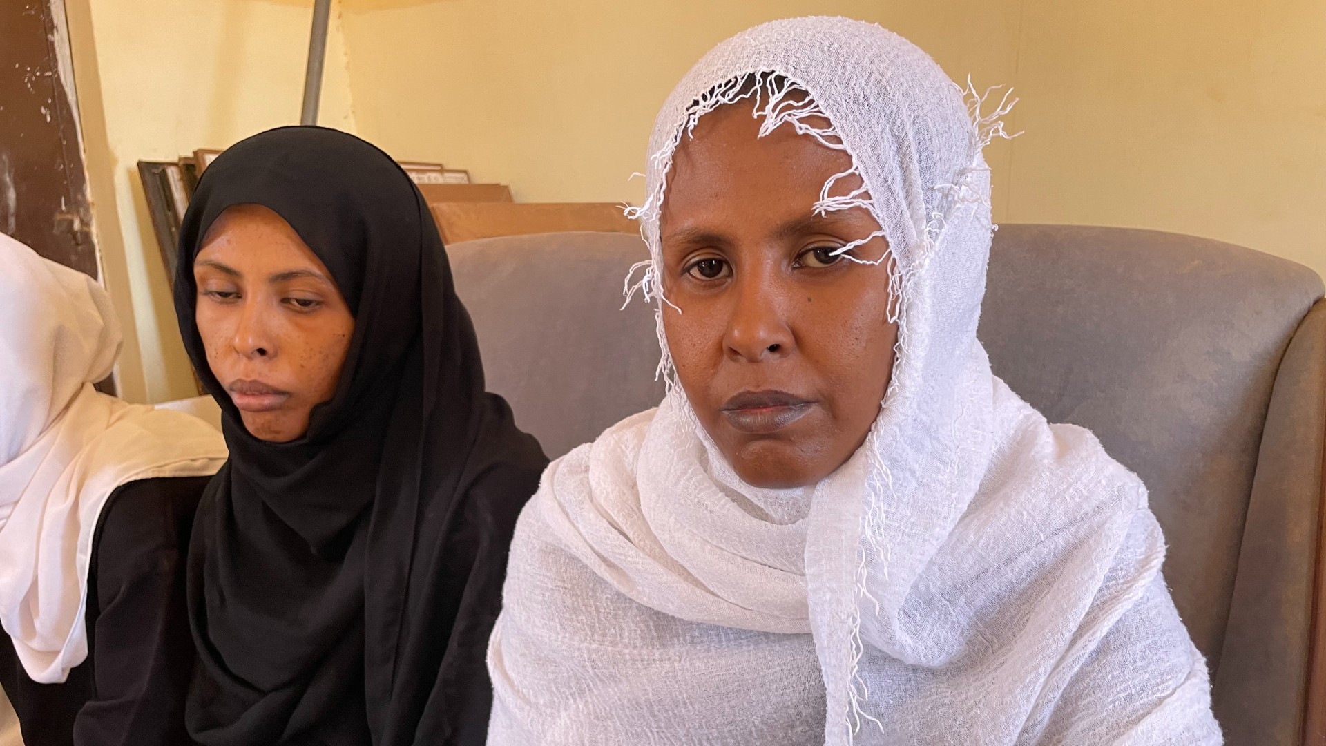 Rihab Ismail (L) and Amal Ismail were separated from their husbands and other men when the convoy they were traveling in was stopped by the paramilitary RSF (Daniel Hilton/MEE)