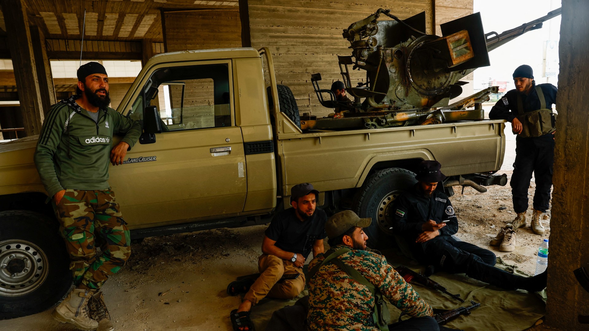 Syrian security forces sit next to a vehicle, in Sahnaya 1 May (Reuters/Yamam Al Shaar)