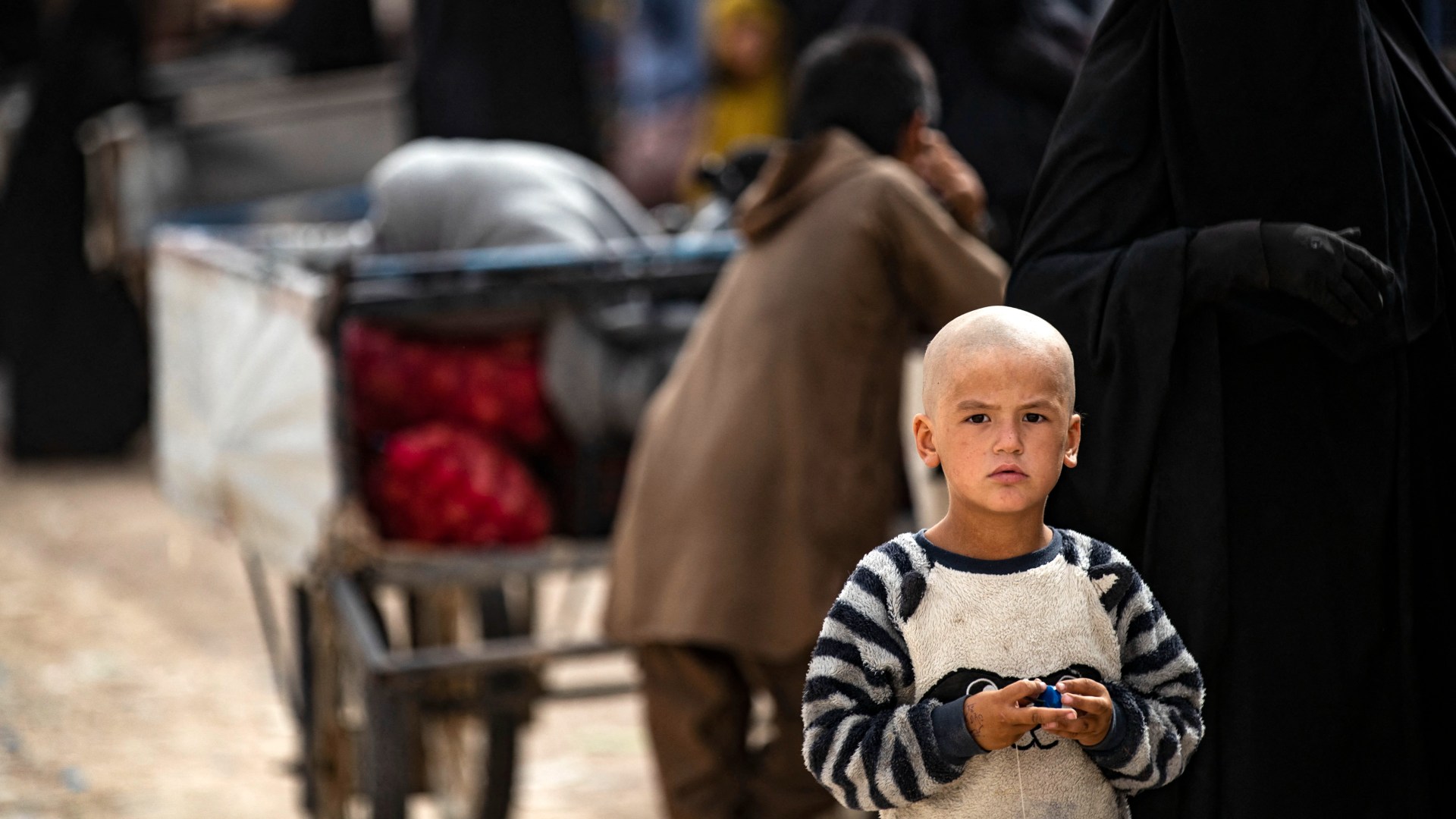 A child looks on while standing at the al-Hol camp in Syria's northeastern Al-Hasakah Governorate, in October 2023. (Delil Souleiman/AFP)