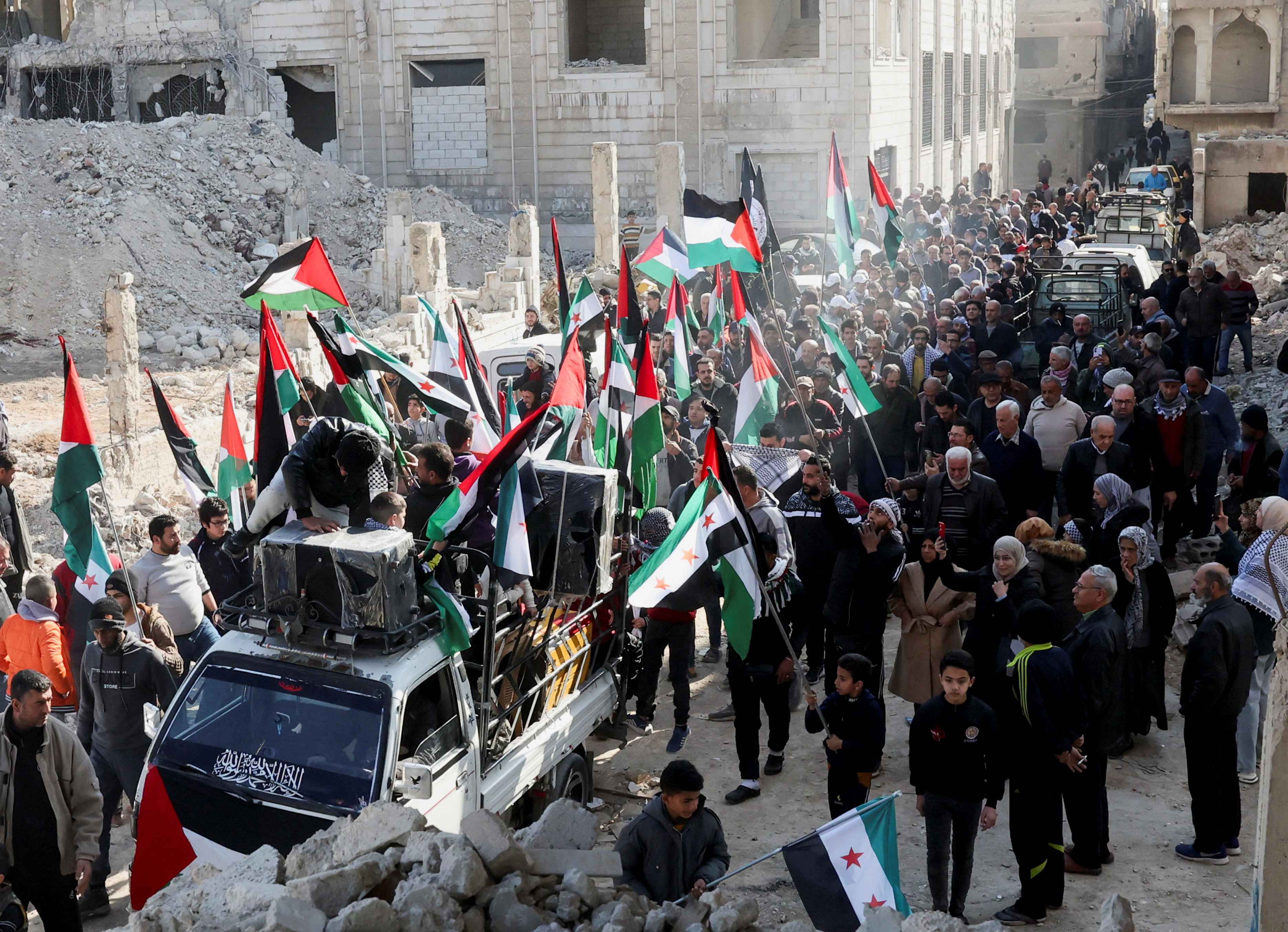 People celebrate the announcement of the ceasefire in Gaza, at Yarmouk camp in Damascus, Syria January 17, 2025 (Reuters/Yamam Al Shaar)