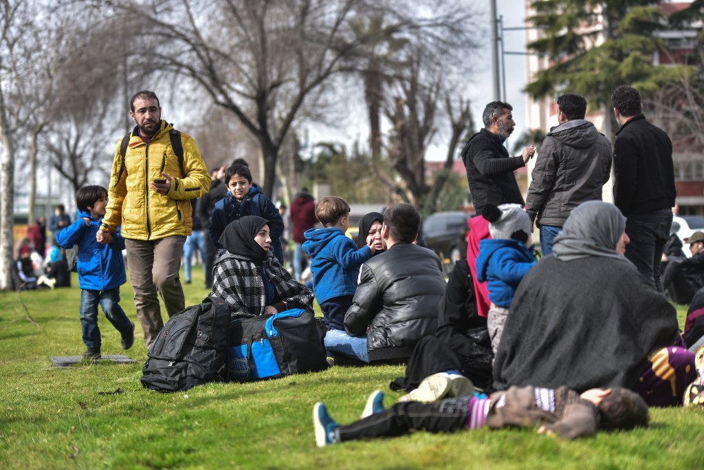 Syrian refugees wait to board a bus in Istanbul as they head towards border villages in Edirne province on 28 February (AFP)