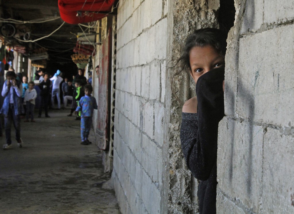 A Syrian refugee shelters in a building in Sidon, Lebanon, in March 2020 (AFP)