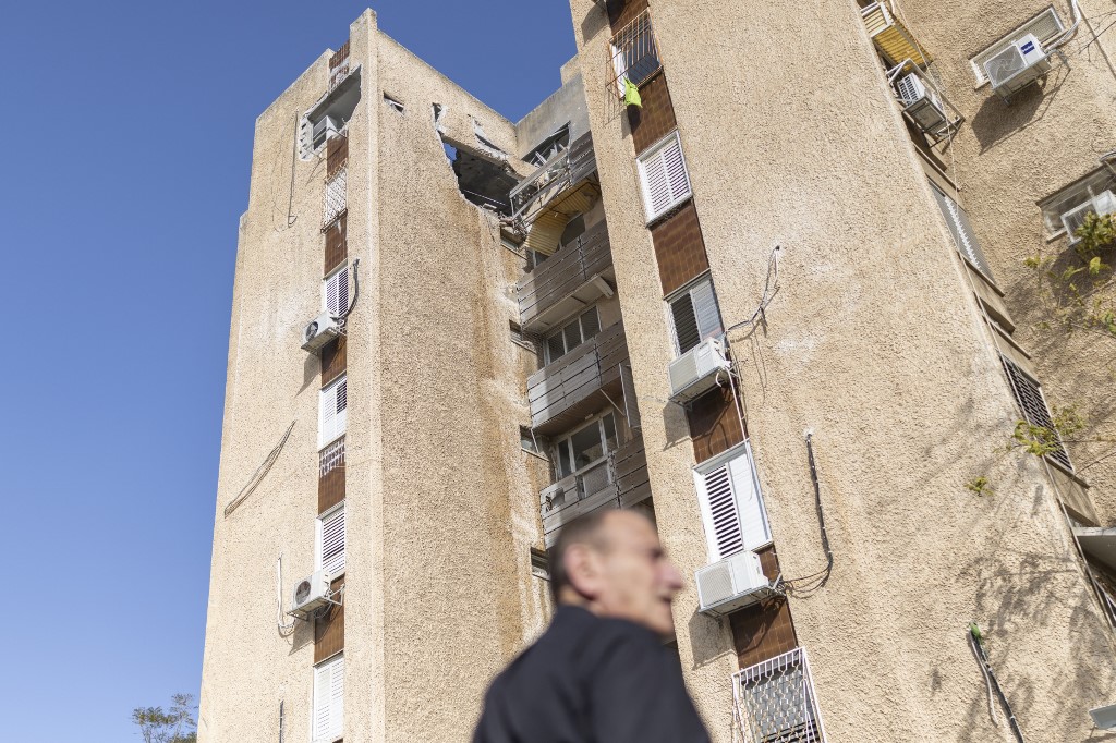 This photograph shows damage to a building following an overnight Iranian missile strike on March 19, 2026. 