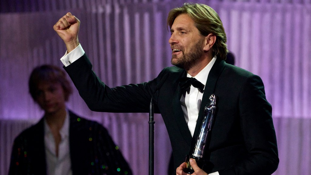 Swedish filmmaker Ruben Ostlund holds a director’s award for Triangle of Sadness at the European Film Awards in Reykjavik on 10 December 2022 (AFP)