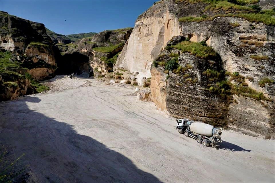 Trucks are seen on the banks of the Tigris river near Hasankeyf, in Turkey's Kurdish-majority southeast, during the construction of the Ilisu dam. (MEE/Nimet Kirac)
