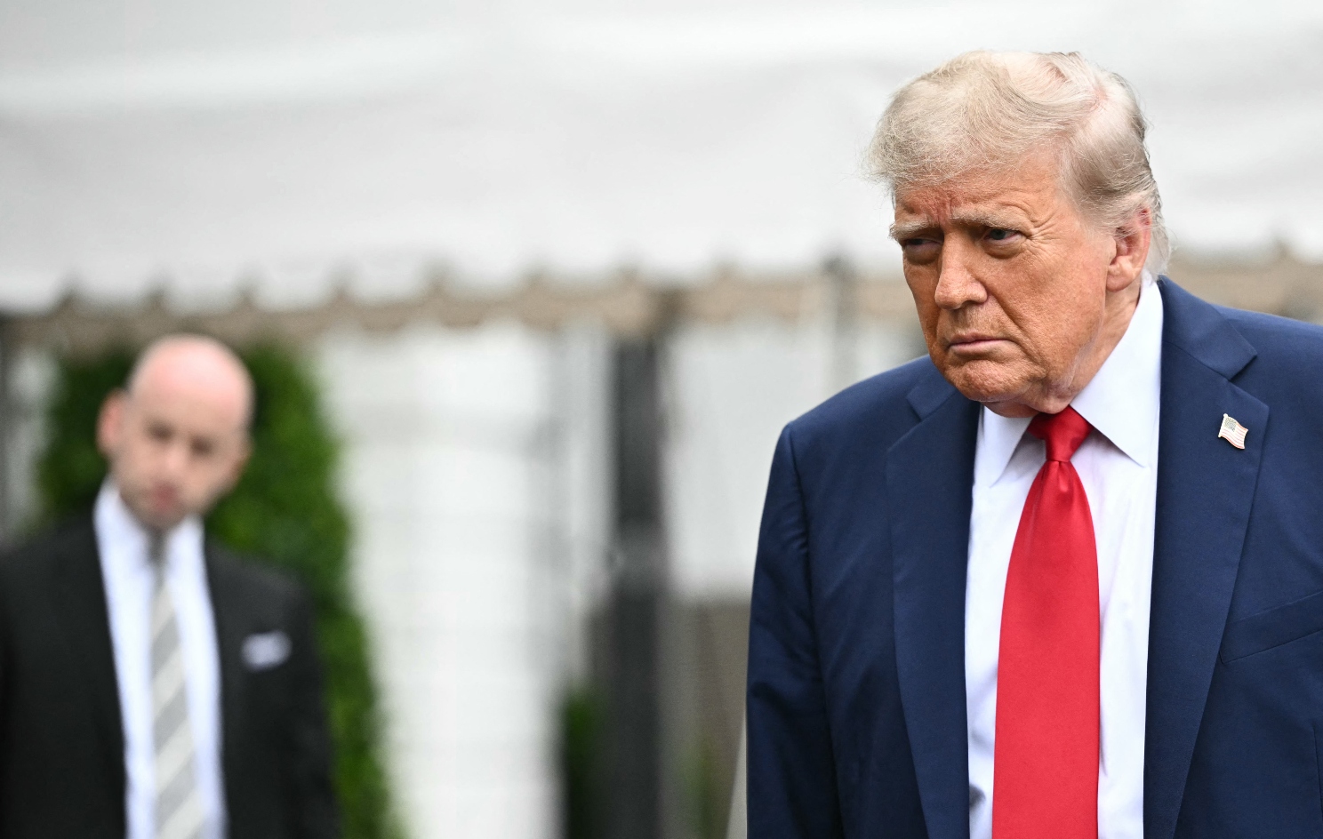 White House Deputy Chief of Staff for Policy and Homeland Security Advisor Stephen Miller watches US President Donald Trump speak to journalists as he makes his way to board Marine One before departing from the South Lawn of the White House in Washington, DC on June 15, 2025