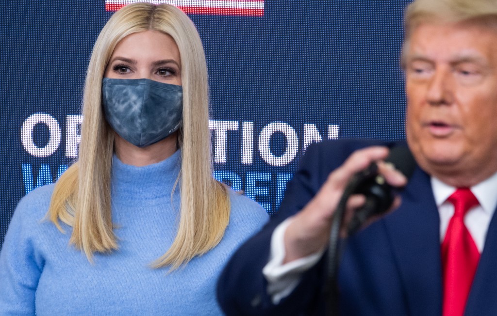 Ivanka Trump, daughter of Donald Trump, stands alongside the US president as he speaks in Washington on 8 December (AFP)