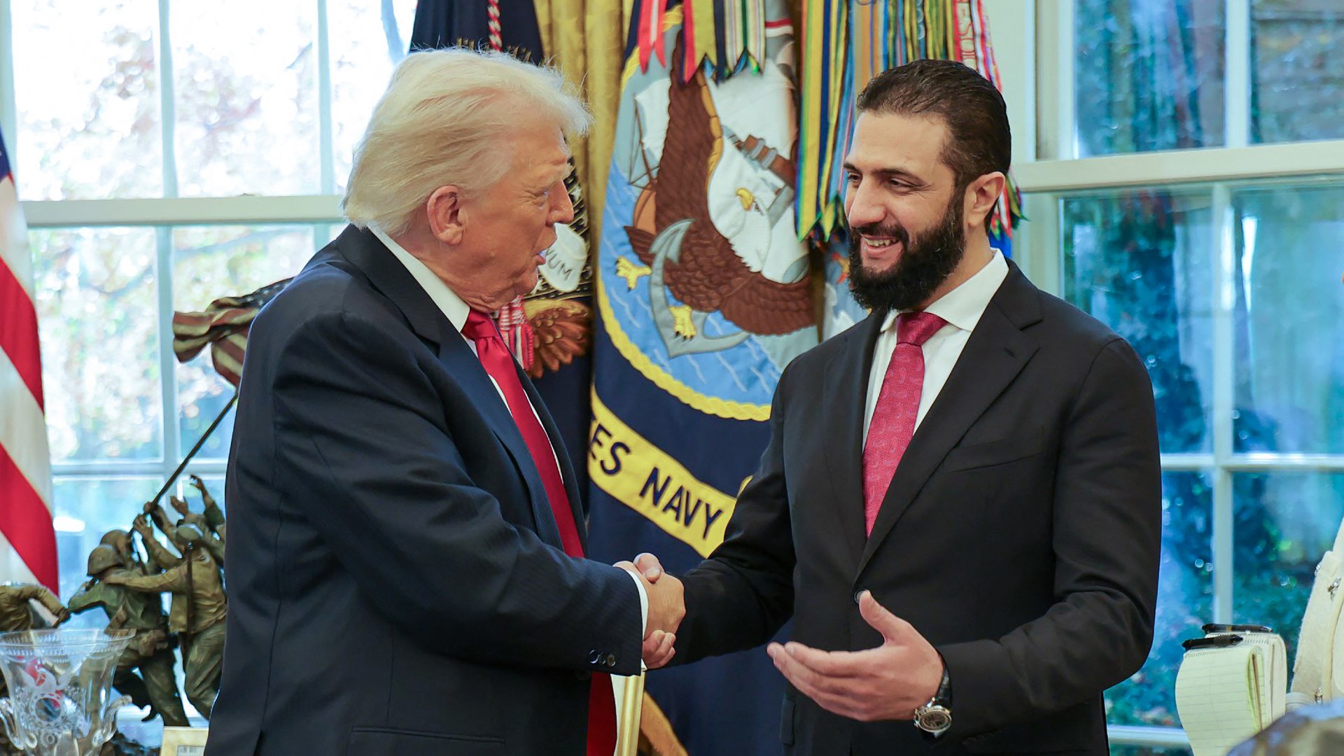 US President Donald Trump shakes hands with Syria's President Ahmed al-Sharaa at the White House in Washington DC (AFP)