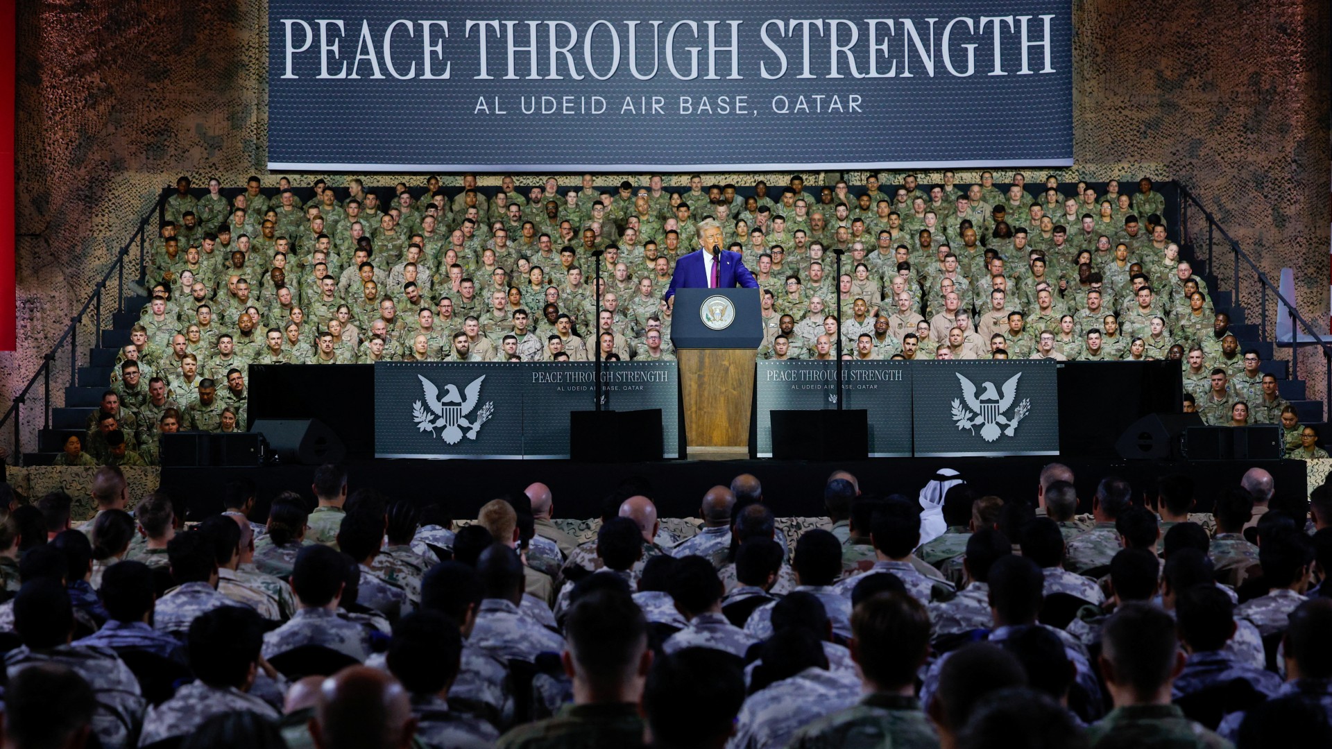US President Donald Trump delivers remarks to US troops, in front of a banner reading, 