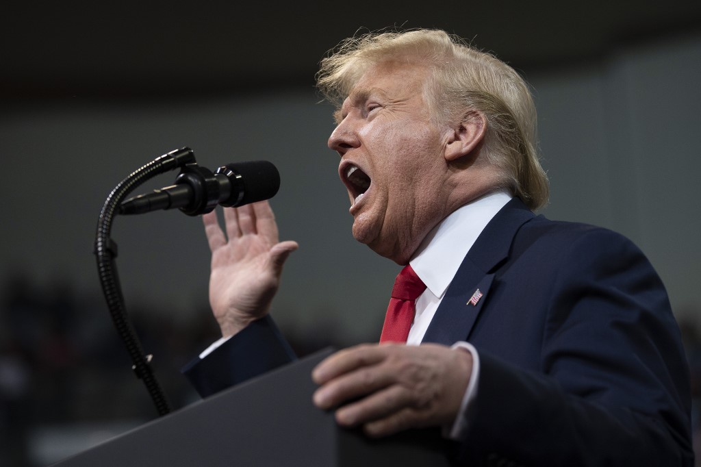 US President Donald Trump speaks at a rally in New Hampshire on 10 February (AFP)
