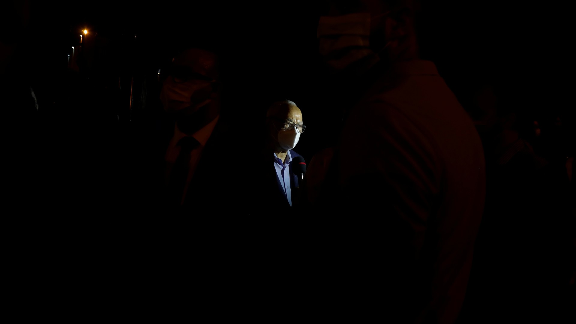 Rached Ghannouchi speaks to journalists outside Tunisia's parliament in the early hours of 26 July 2021 following President Kais Saied's power grab (Zoubeir Souissi/Reuters)