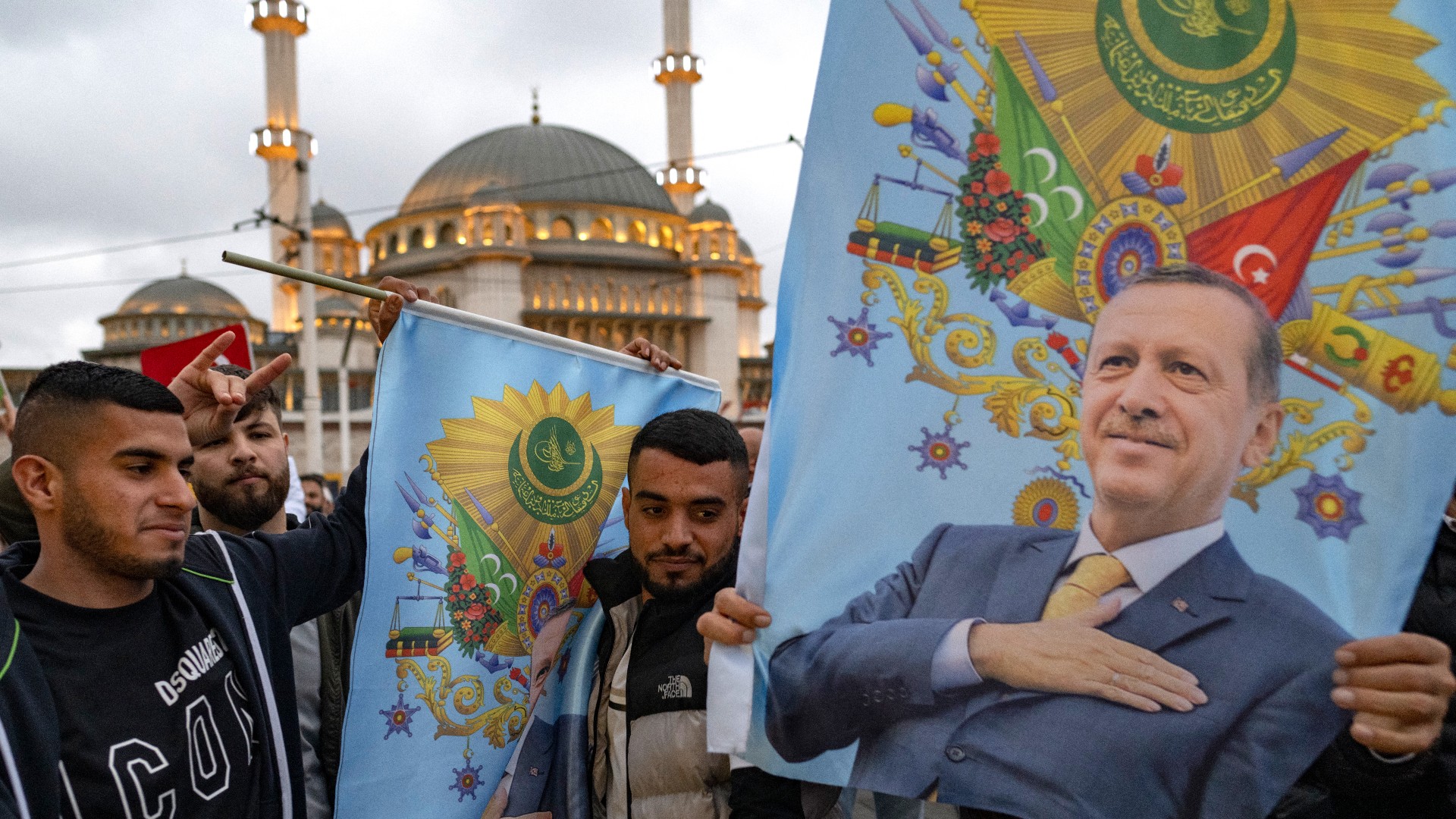 Supporters of Turkish President Recep Tayyip Erdogan celebrate near Taksim Mosque at the Taksim Square in Istanbul on the day of the Presidential runoff vote in Istanbul, on May 28, 2023. Turkish President Recep Tayyip Erdogan declared victory on May 28, 2023 
