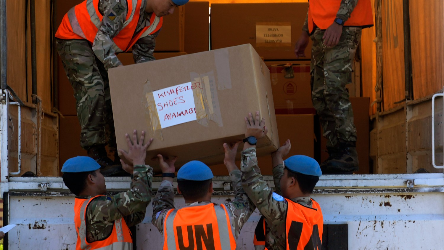 British soldiers serving with the United Nations Peacekeeping Force in Cyprus (UNFICYP) load a truck with 105 boxes of food, clothing, water and blankets donated by Greek Cypriots in the south of the ethnically divided island nation to be transferred to the breakaway Turkish Cypriot north from where it will be taken to Turkey for distribution to earthquake victims at the vacant Ledra Palace hotel inside a U.N. controlled buffer zone in the divided capital Nicosia, Cyprus, Wednesday, 15 February 2023.