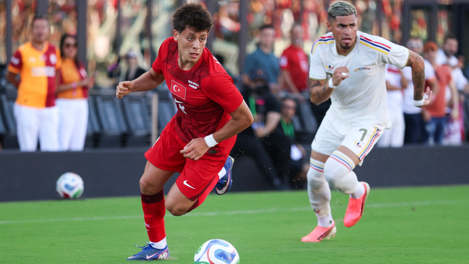 Turkey's Arda Guler dribbles the ball past Venezuela's Gleiker Mendoza during the first half of their international friendly match at the Chase Stadium in Fort Lauderdale, Florida, on 6 June 2026 (AFP/Tomas Diniz Santos)