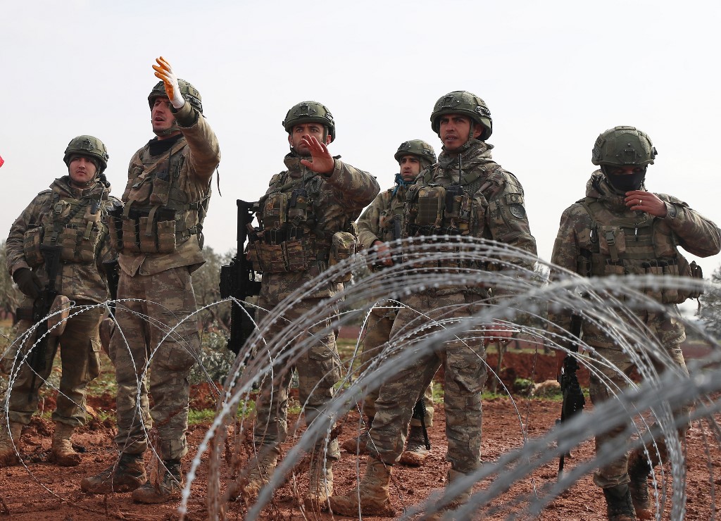 Turkish soldiers stand at an observation post in Syria’s Idlib province on 14 February (AFP)