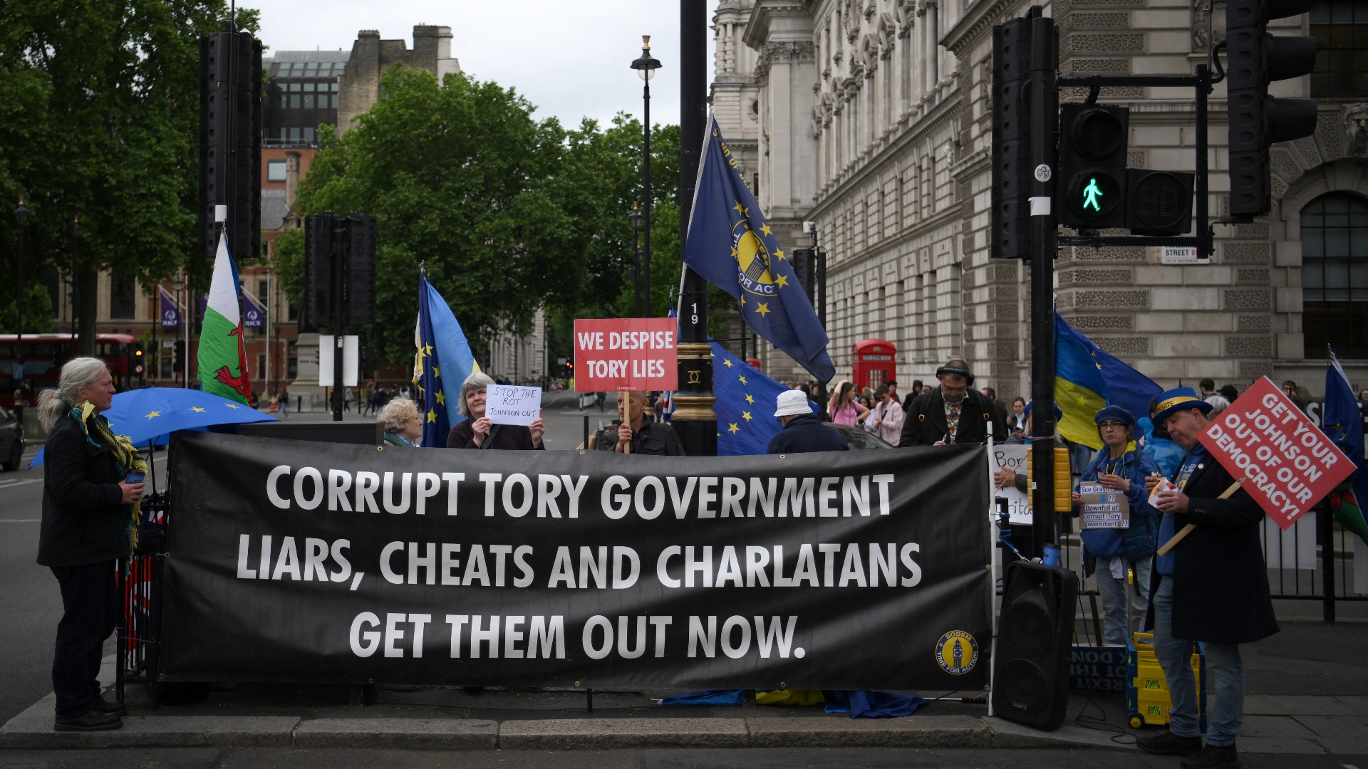 Demonstrators protest against Britain's Prime Minister Boris Johnson, as he makes a statement in the House of Commons in London, on May 25, 2022 following the publication of the Sue Gray report
