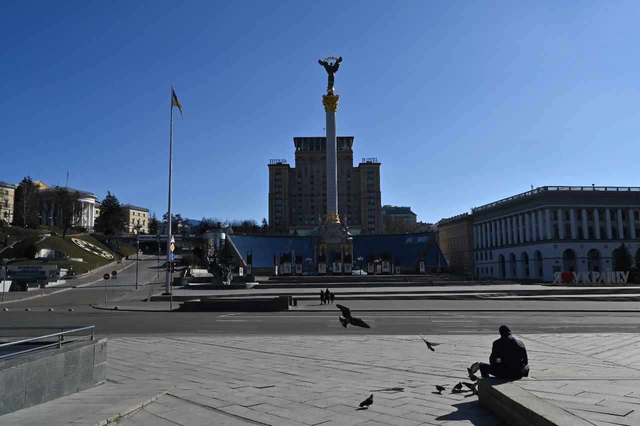 A man sits at Kyiv's Independence Square, an iconic place for Ukrainians, on February 28, 2022