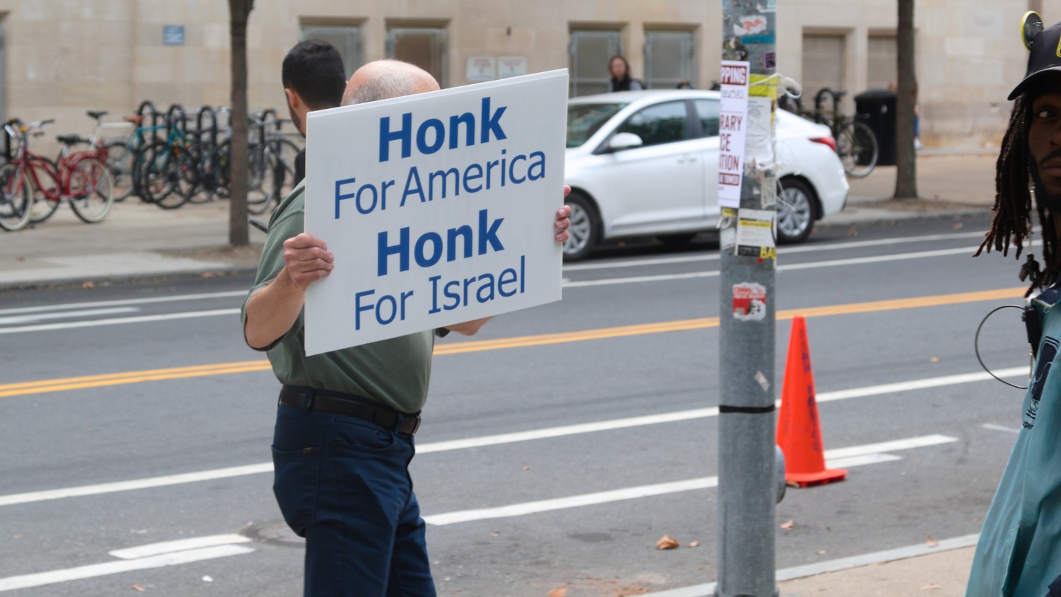 A man stands outside the Palestine Writes festival on 22 September 2023 holding a poster stating 