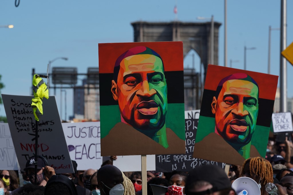 People march in protest over the death of George Floyd in New York on 19 June (AFP)