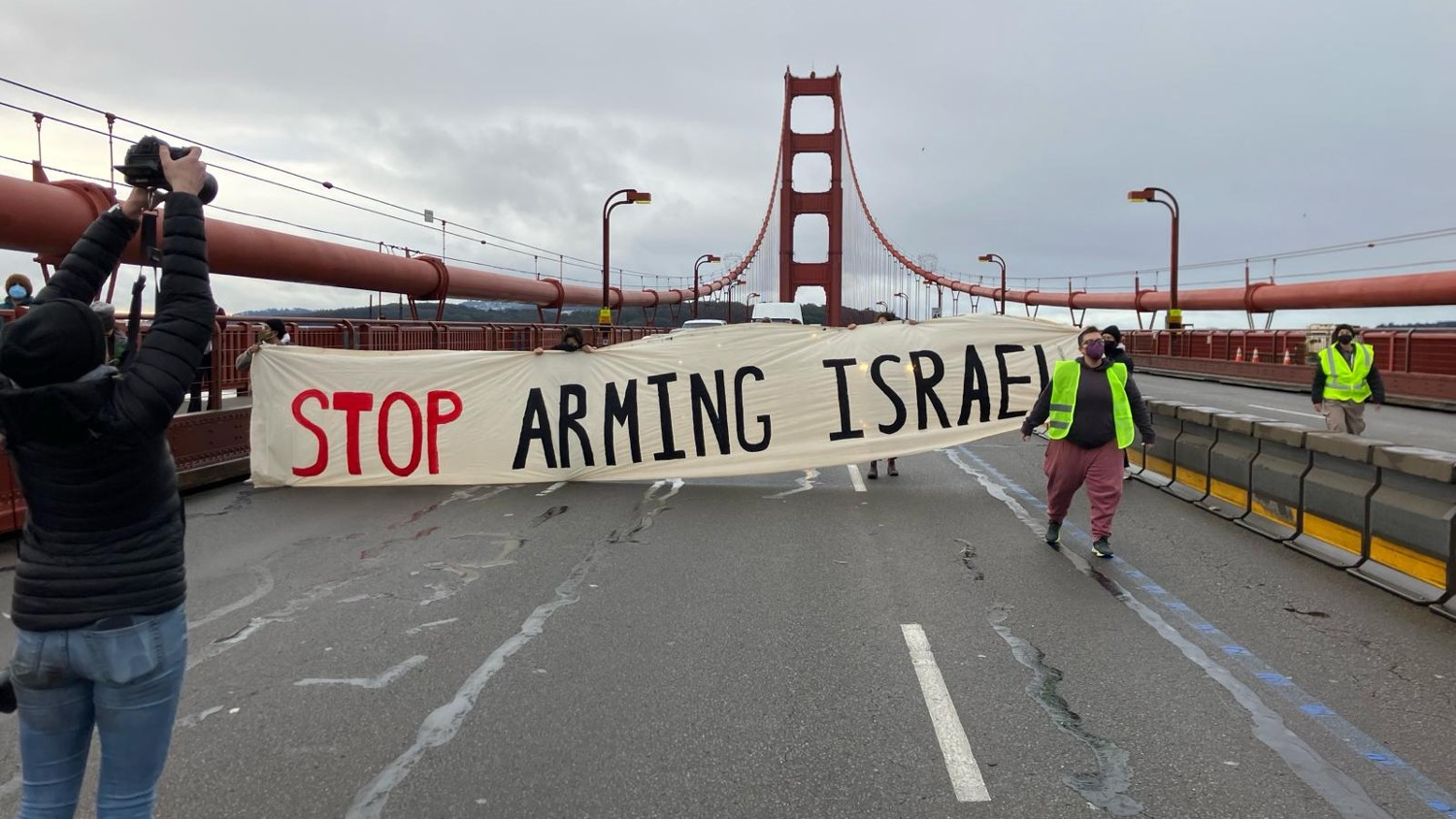 Pro-Palestine protesters disrupt traffic on the Golden Gate Bridge in California, holding a banner saying 
