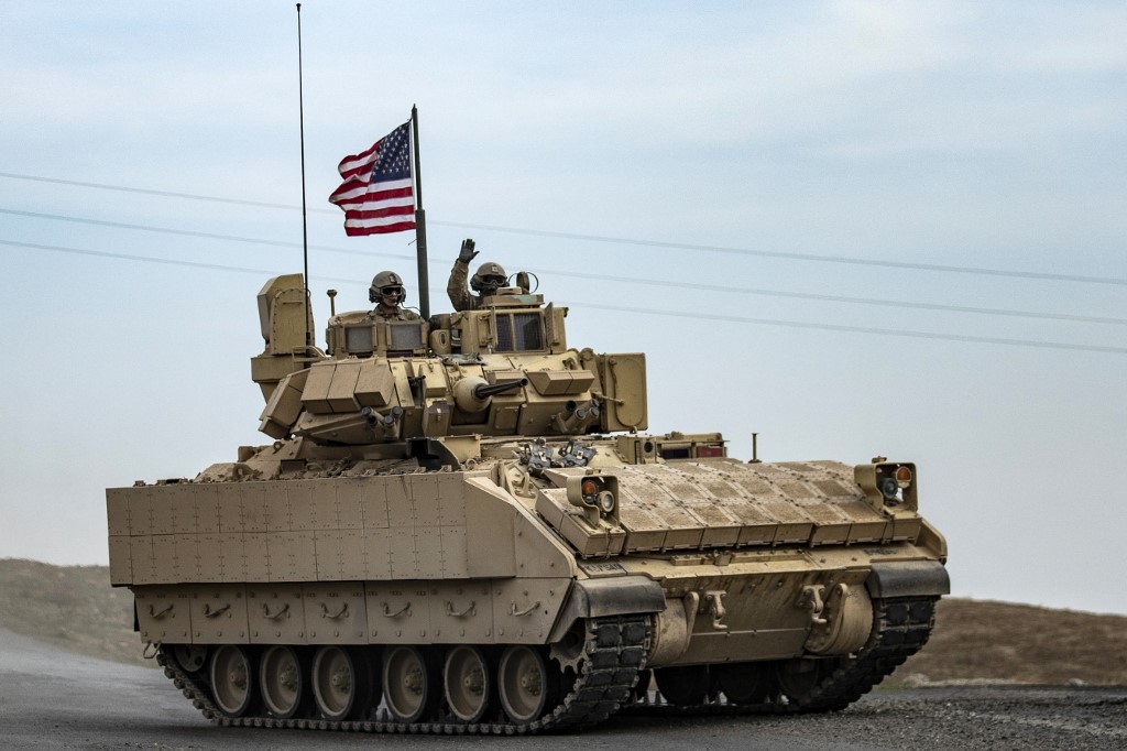 US soldiers patrol an area near the Syria-Iraq border on 12 January 2021 (AFP)