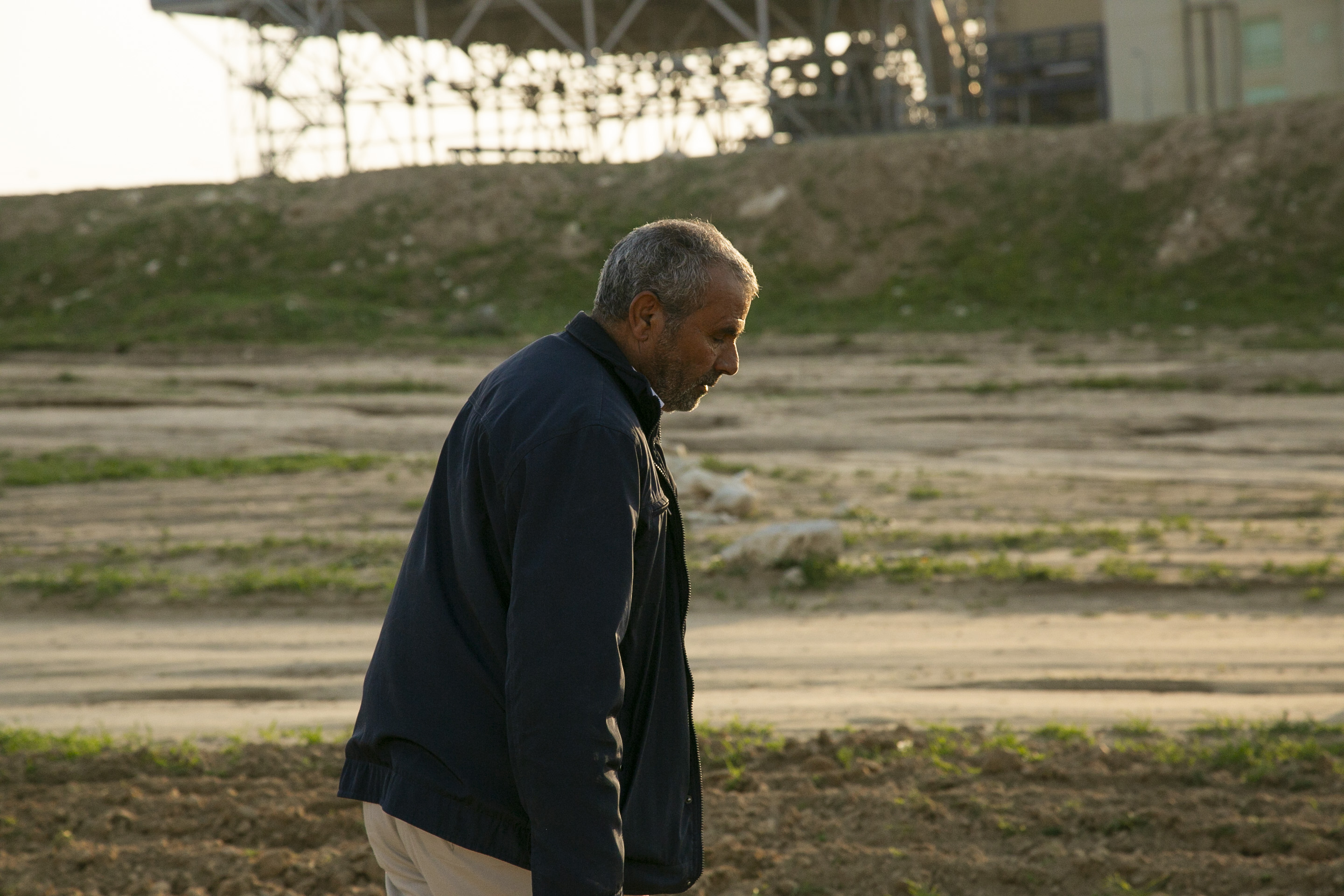 Me'eqel Al Hawashla inspects the damage to Wadi al Na'am's agricultural land (MEE/Jack Dodson)