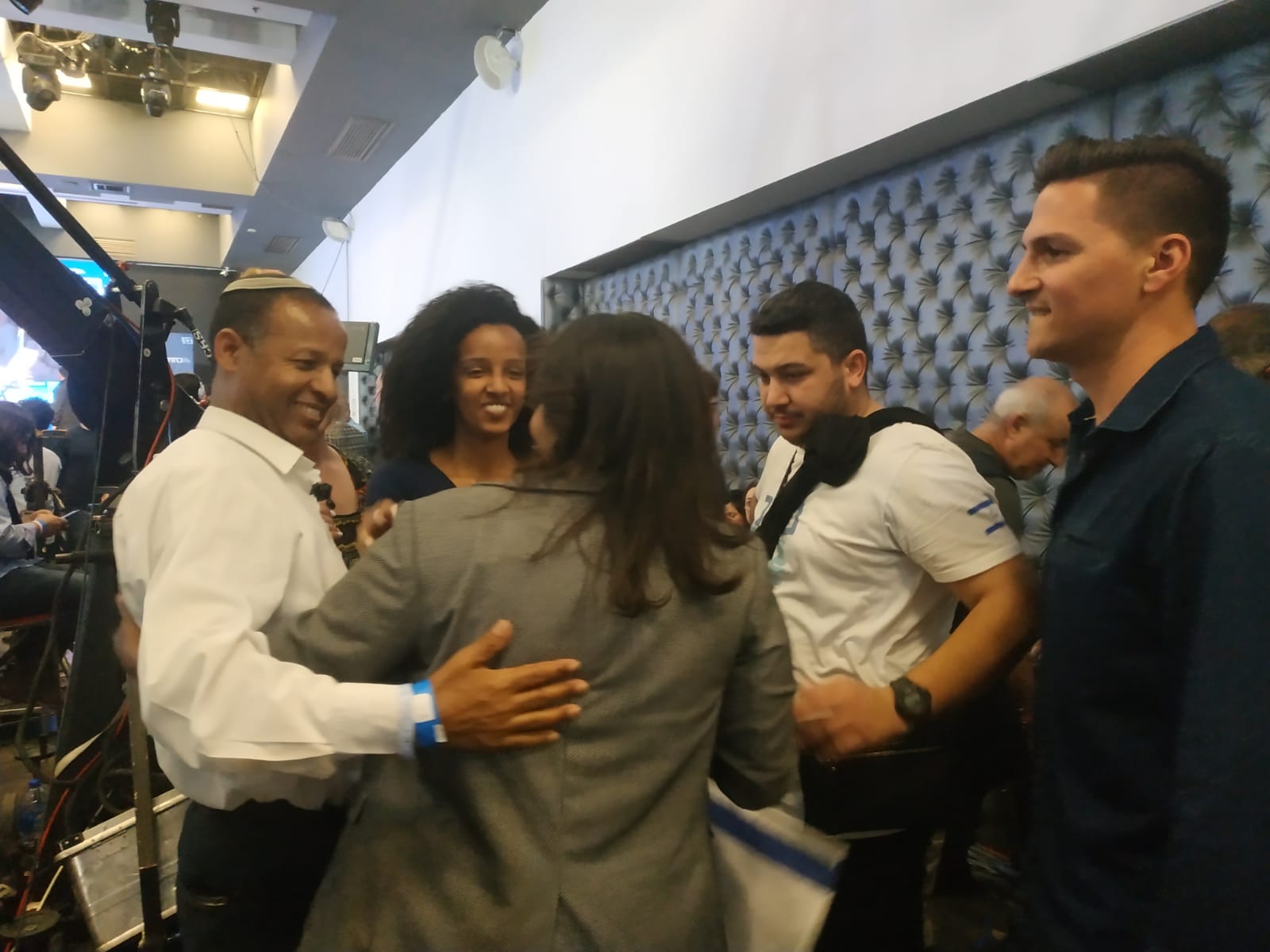 Gady Yavrkan, left, celebrates with Blue and White supporters (MEE)
