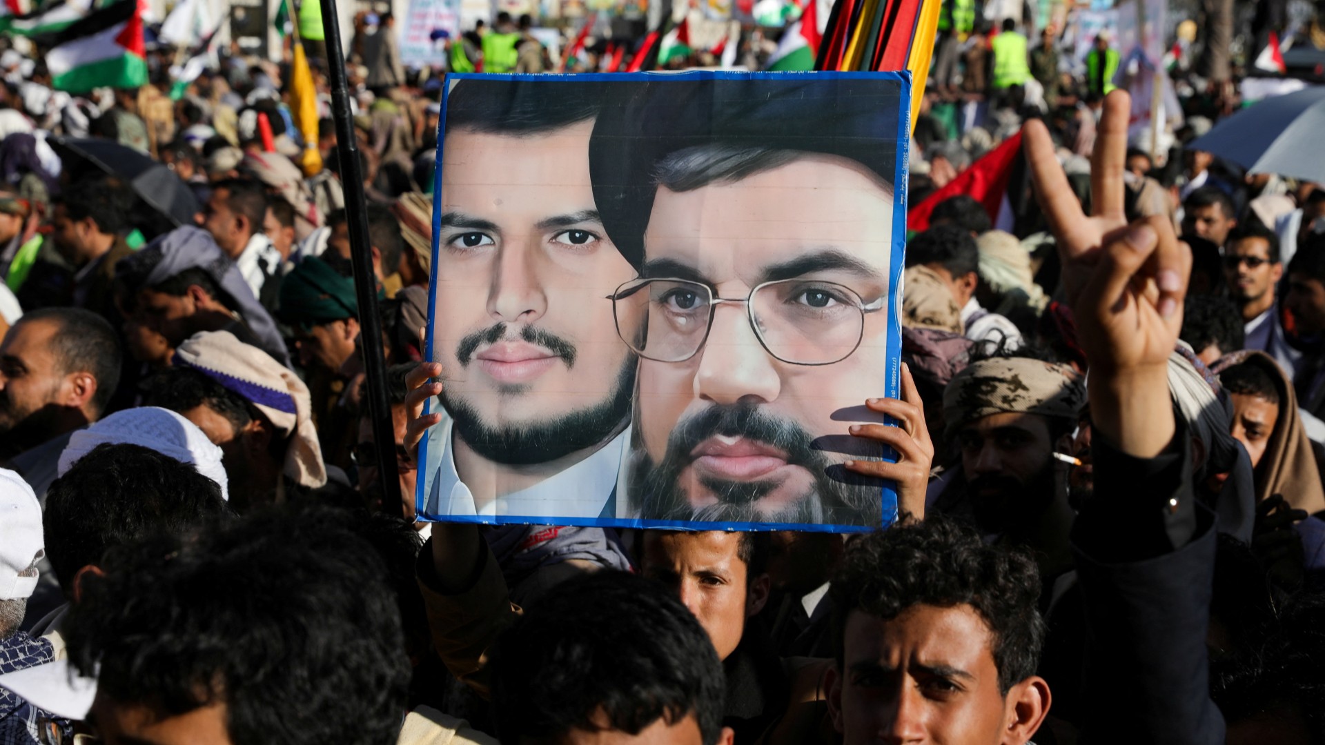 Some protesters raised pictures Abdel Malik al-Houthi, leader of the Ansarullah movement, and Hezbollah's Hassan Nasrallah, at the protest in solidarity with Palestinians on 2 Feb 2024 (Reuters)
