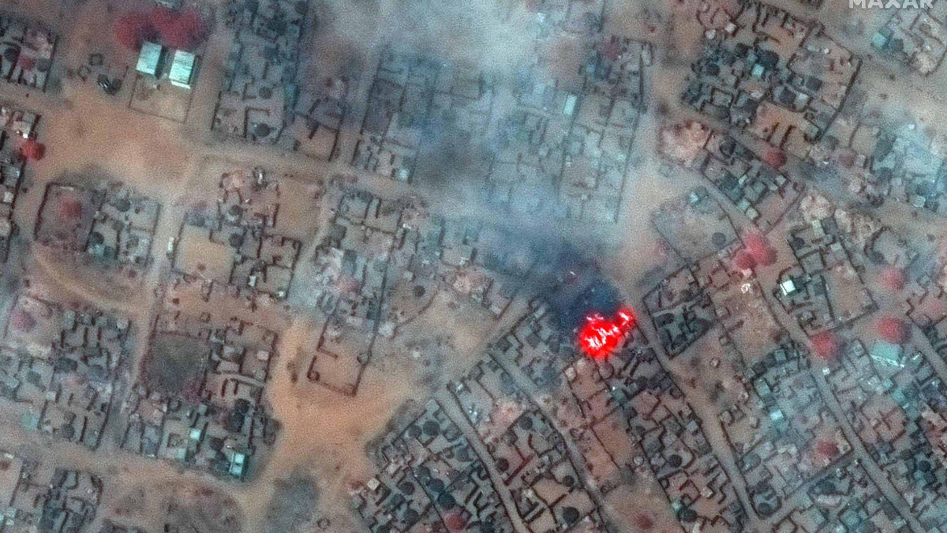 A satellite image shows smoke and fire in Zamzam camp on 11 April (Maxar Technologies/Reuters)