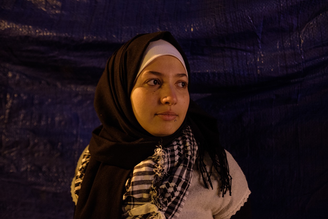 Zeina Kaissi outside the tent she visits in Riad al-Solh Square almost daily after she finishes work (MEE/Rita Kabalan)